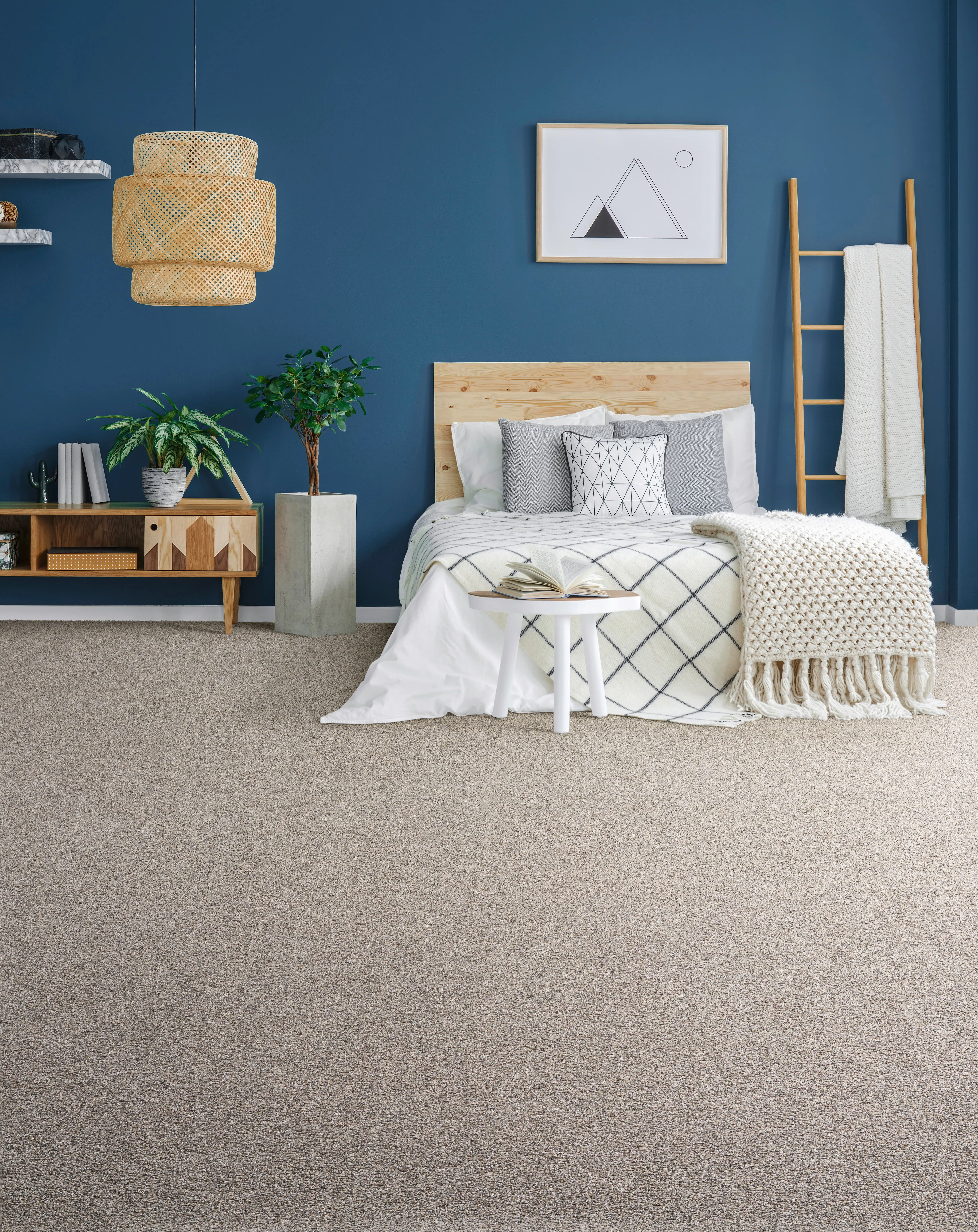 Cozy bedroom with plush carpet, blue walls, and modern decor.