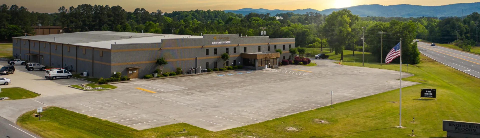 Aerial view of Engineered Floors employee center with surrounding greenery and parking lot.